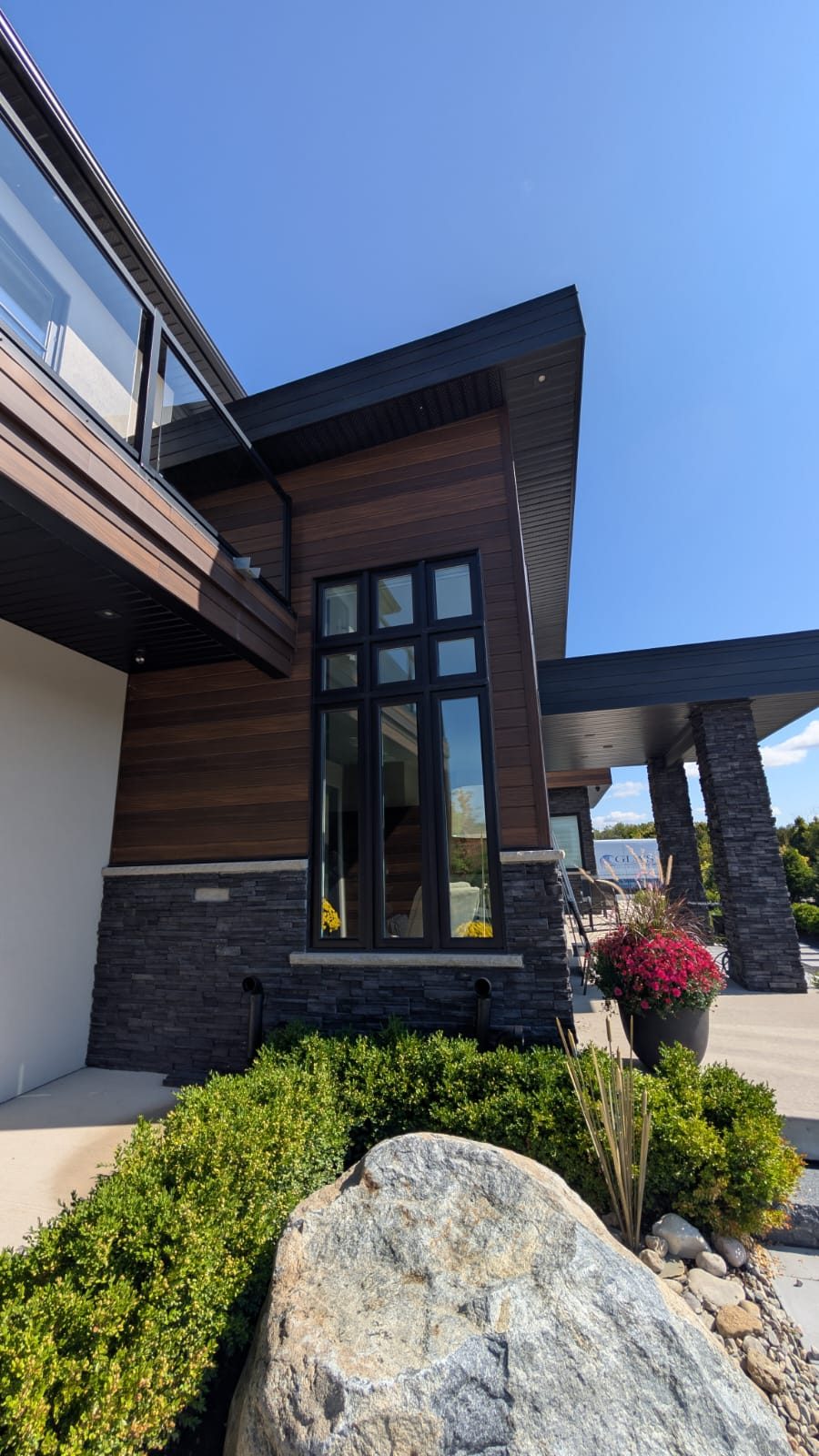 Ontario Window Cleaning crew cleaning windows at a Burlington home — streak-free, purified-water system.