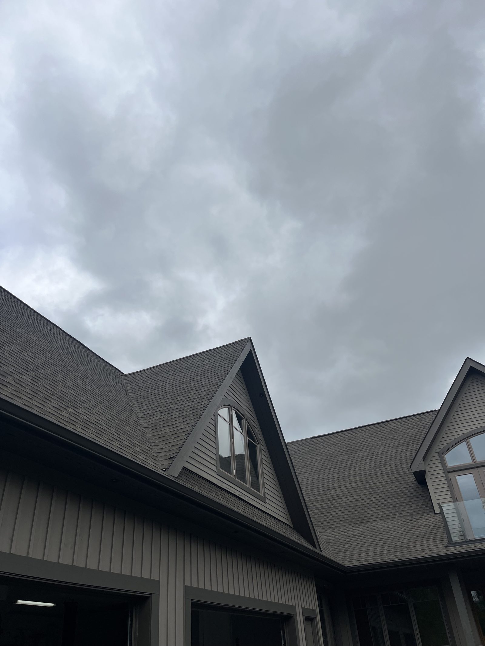 Ontario Window Cleaning crew cleaning windows at a Huntsville home — streak-free, purified-water system.